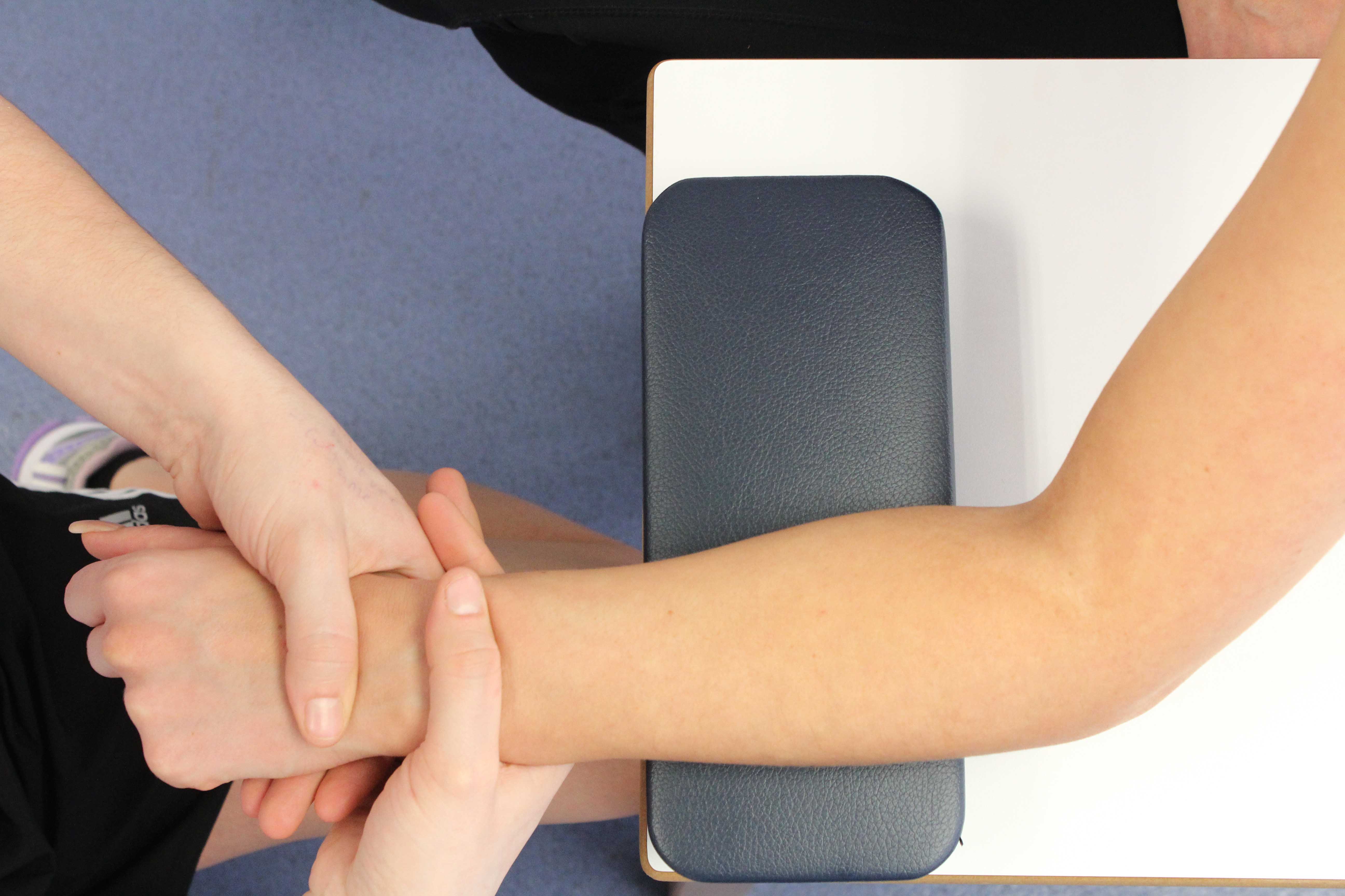 One of our physiotherpaist providing hand treatment for a patient suffering from hand osteoarthritis.