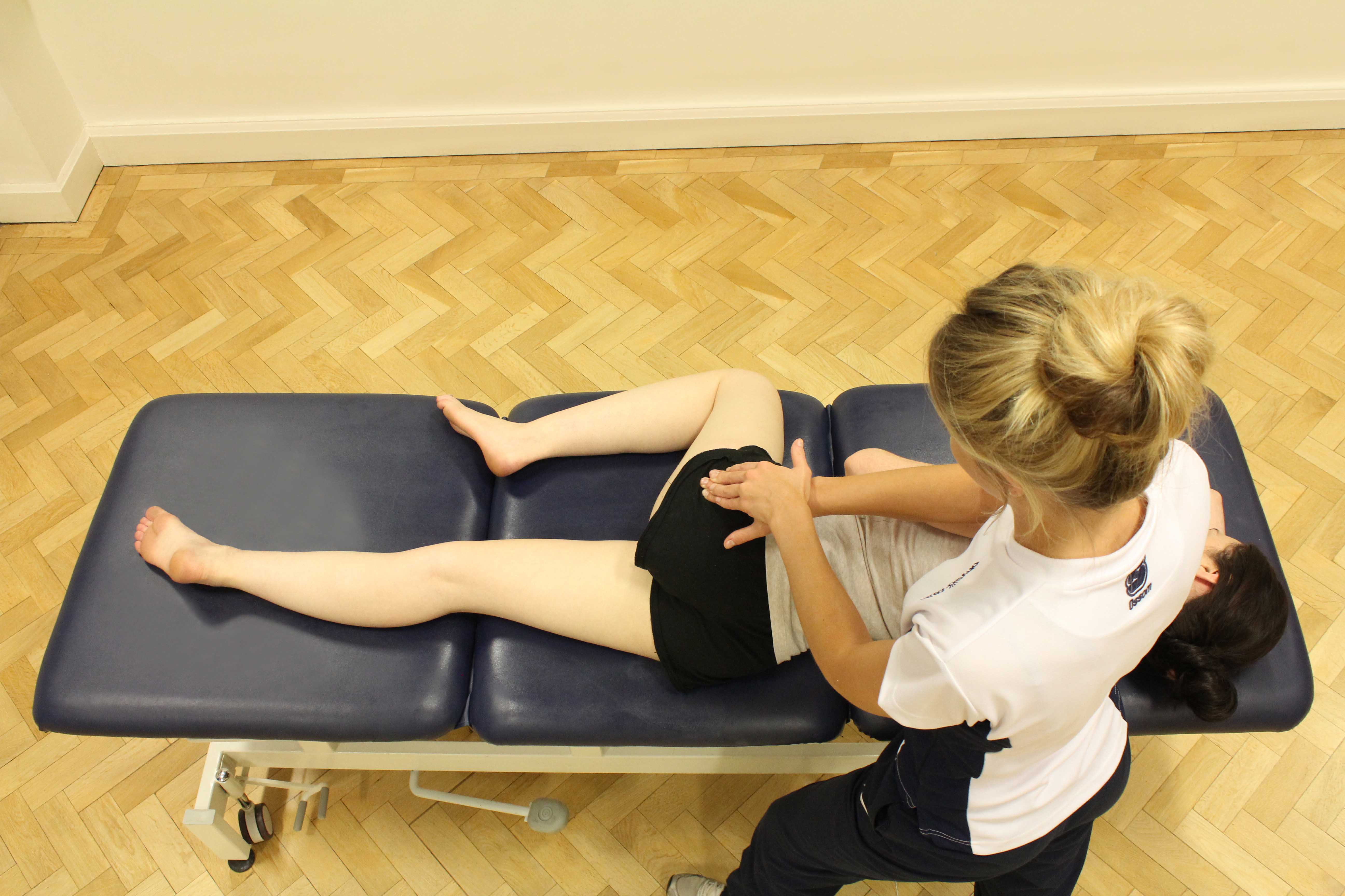 Soft tissue massage of the muscles and connective tissues around the hip