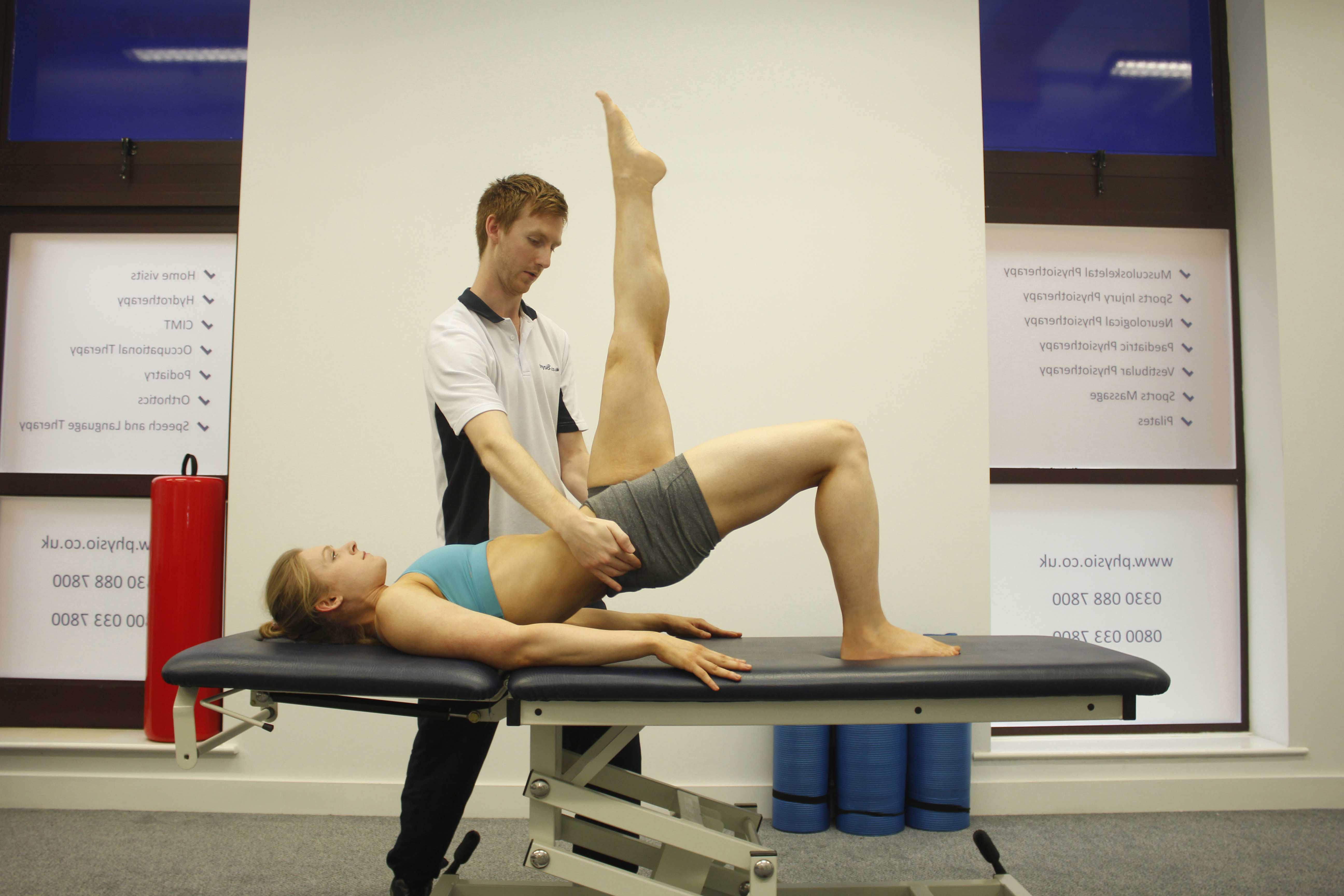 Passive stretch applied by physiotherapist to calf and hamstring muscles