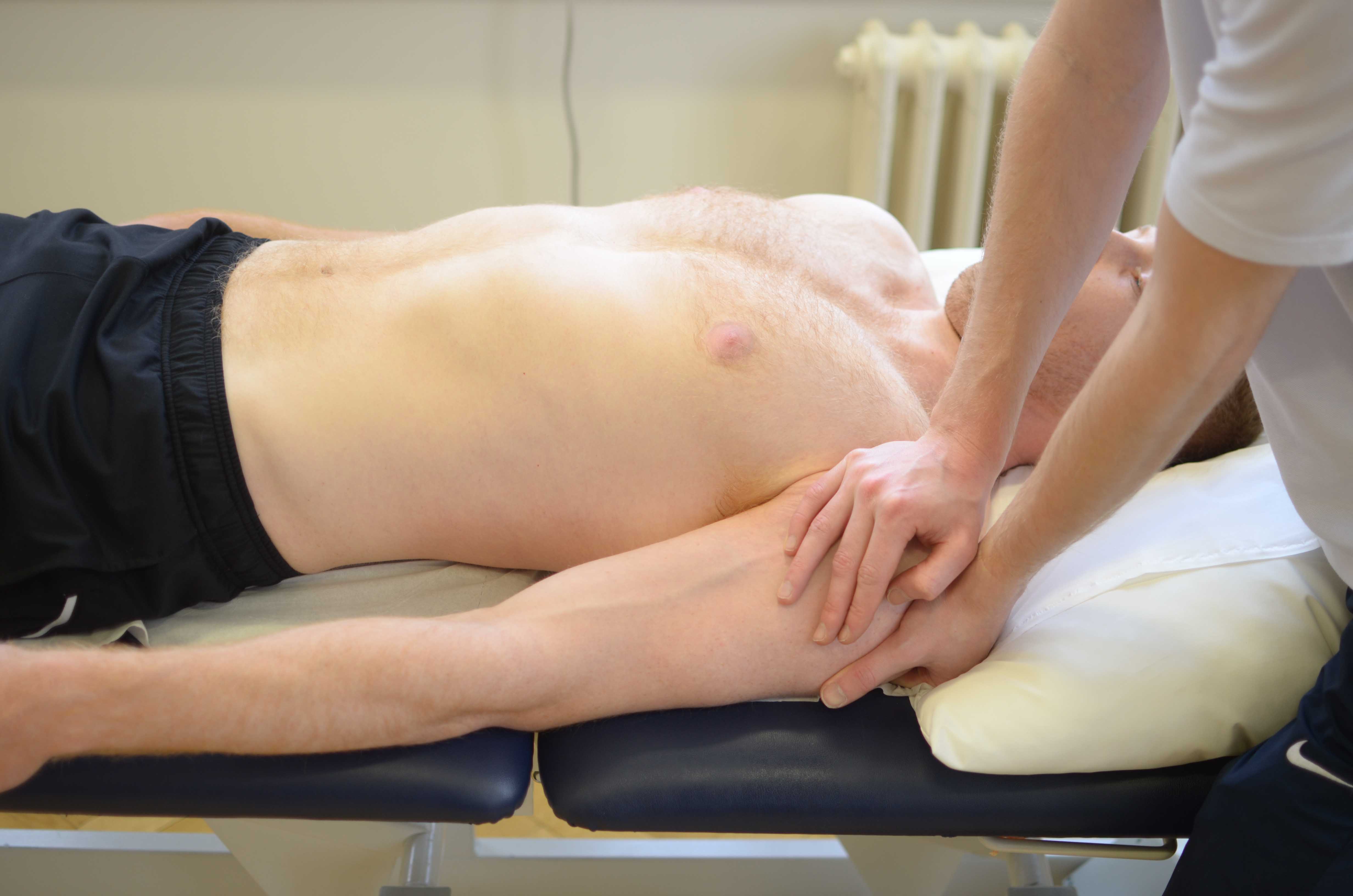 Therapist providing mobalisations to the shoulder in order to regain range of movement following surgery